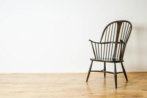 Single Windsor style chair in empty room Stock Photos