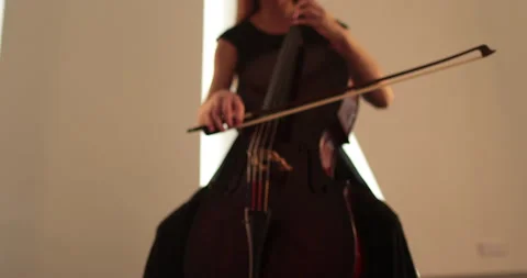 Single woman playing the cello, close-up and medium Stock Footage 240123251