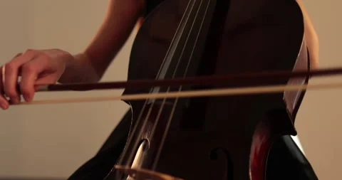 Single woman playing the cello, close-up and medium Stock Footage 240123406