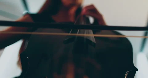 Single woman playing the cello, close-up and medium Stock Footage 240123556