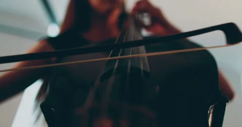 Single woman playing the cello, close-up and medium Stock Footage 240123574