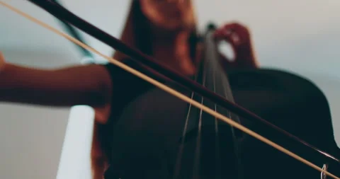 Single woman playing the cello, close-up and medium Stock Footage 240123683