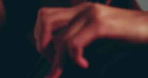 Single woman playing the cello, close-up and medium Stock Footage 240124145