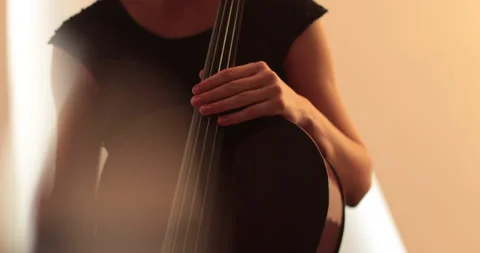 Single woman playing the cello, close-up and medium Stock Footage 240124491