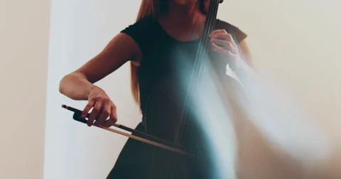 Single woman playing the cello, close-up and medium Stock Footage 240124630