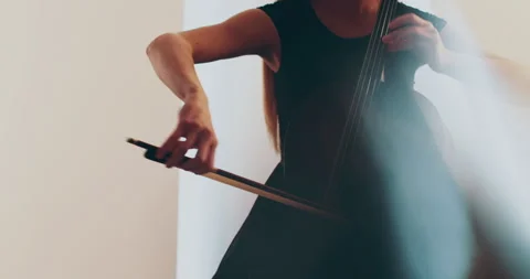 Single woman playing the cello, close-up and medium Stock Footage 240124645