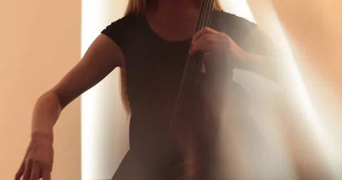 Single woman playing the cello, close-up and medium Stock Footage 240124772