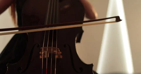 Single woman playing the cello, close-up and medium Stock Footage 240126866