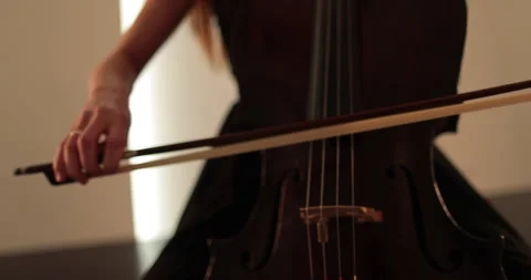 Single woman playing the cello, close-up and medium Stock Footage 240127452