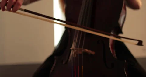 Single woman playing the cello, close-up and medium Stock Footage 240127610