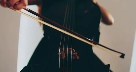 Single woman playing the cello, close-up and medium Stock Footage 240128101