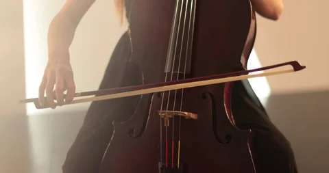 Single woman playing the cello, close-up and medium Stock Footage 240128457