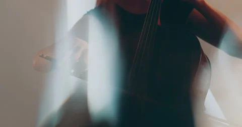 Single woman playing the cello, close-up and medium Stock Footage 240128852