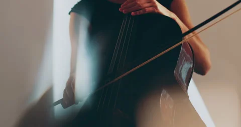 Single woman playing the cello, close-up and medium Stock Footage 240129007