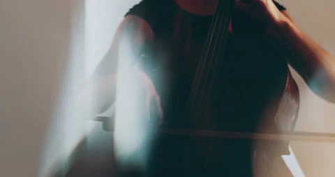 Single woman playing the cello, close-up and medium Stock Footage 240129124