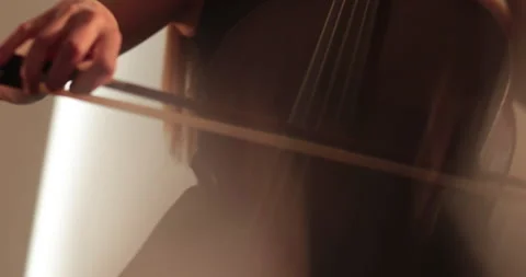 Single woman playing the cello, close-up and medium Stock Footage 240129480