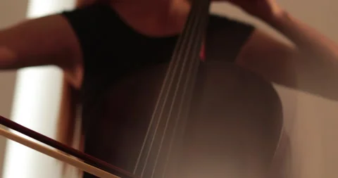 Single woman playing the cello, close-up and medium Stock Footage 240129929