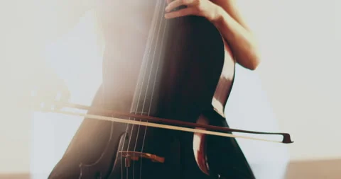 Single woman playing the cello, close-up and medium Stock Footage 240130787