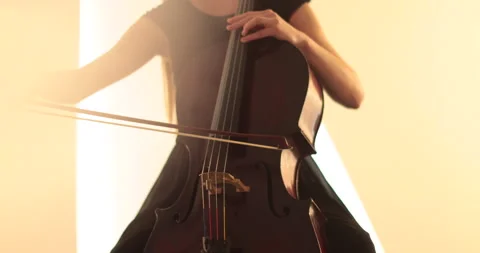 Single woman playing the cello, close-up and medium Stock Footage 240131067