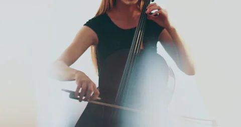 Single woman playing the cello, close-up and medium Stock Footage 240131176