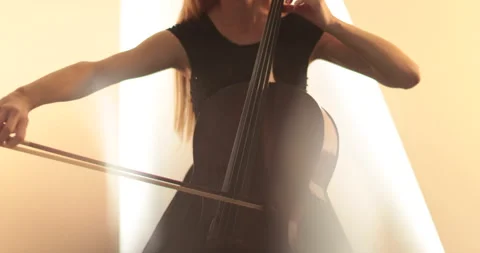 Single woman playing the cello, close-up and medium Stock Footage 240131676