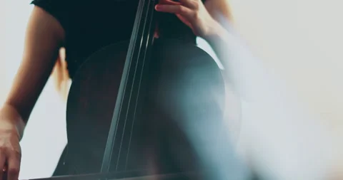 Single woman playing the cello, close-up and medium Stock Footage 240131876