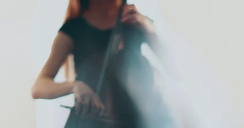 Single woman playing the cello, close-up and medium Stock Footage 240131949