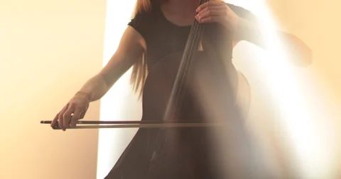 Single woman playing the cello, close-up and medium Stock Footage 240132152
