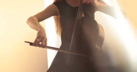 Single woman playing the cello, close-up and medium Stock Footage 240132235