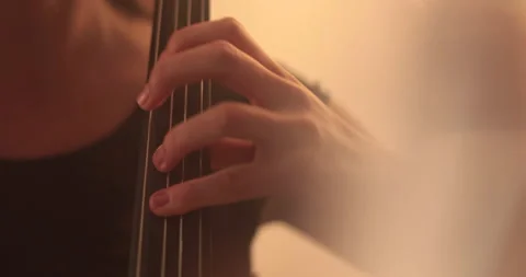 Single woman playing the cello, close-up and medium Stock Footage 240132559