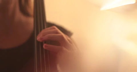 Single woman playing the cello, close-up and medium Stock Footage 240132726
