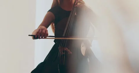 Single woman playing the cello, close-up and medium Stock Footage 240132809