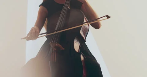 Single woman playing the cello, close-up and medium Stock Footage 240133267