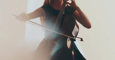 Single woman playing the cello, close-up and medium Stock Footage 240133738