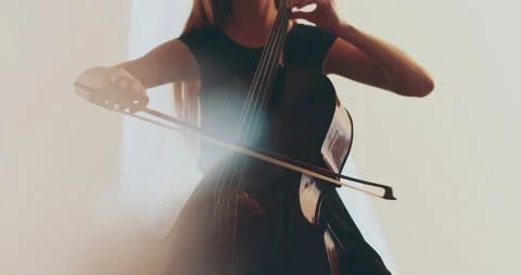 Single woman playing the cello, close-up and medium Stock Footage 240133739