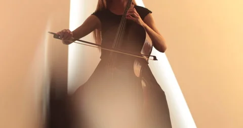 Single woman playing the cello, close-up and medium Stock Footage 240133934