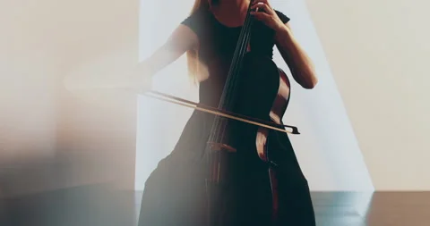 Single woman playing the cello, close-up and medium Stock Footage 240134093