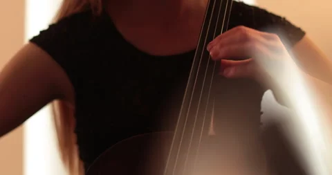 Single woman playing the cello, close-up and medium Stock Footage 240134428