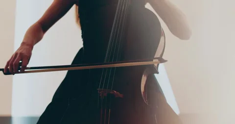 Single woman playing the cello, close-up and medium Stock Footage 240134537