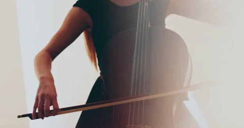 Single woman playing the cello, close-up and medium Stock Footage 240134675