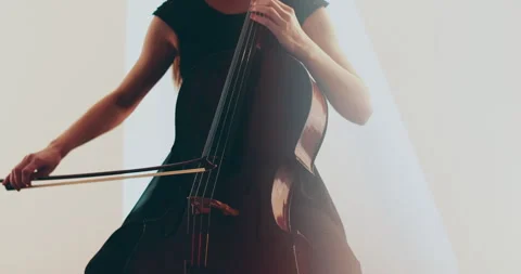Single woman playing the cello, close-up and medium Stock Footage 240134734