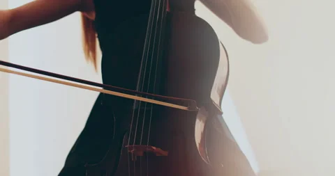 Single woman playing the cello, close-up and medium Stock Footage 240134776