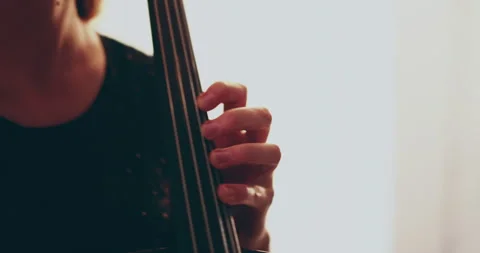 Single woman playing the cello, close-up and medium Stock Footage 240134779