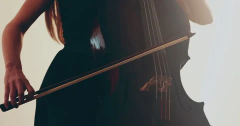 Single woman playing the cello, close-up and medium Stock Footage 240135178