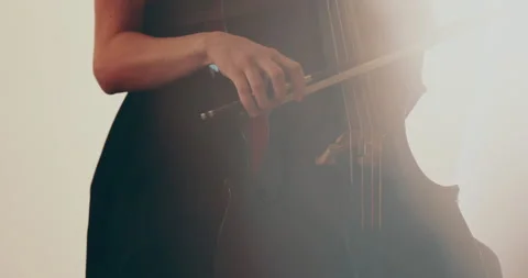 Single woman playing the cello, close-up and medium Stock Footage 240135239