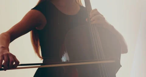 Single woman playing the cello, close-up and medium Stock Footage 240135638