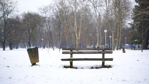Single wood bench in a snow-covered park, Zagreb, Croatia. Stock-Footage 102644304