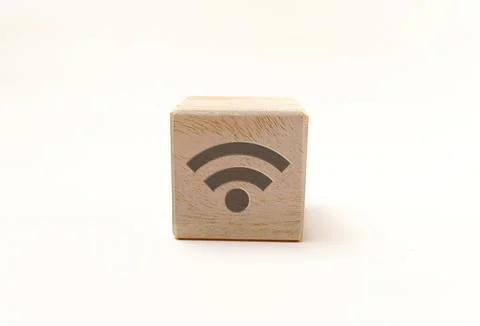 Single wooden block cube featuring a gray Wi-Fi signal icon on natural grai.. Stock Photos
