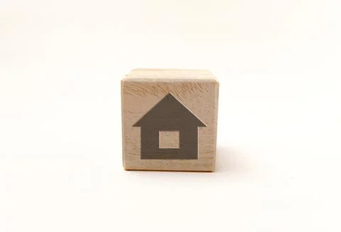 Single wooden block cube featuring a gray house home icon on natural grain .. Stock Photos