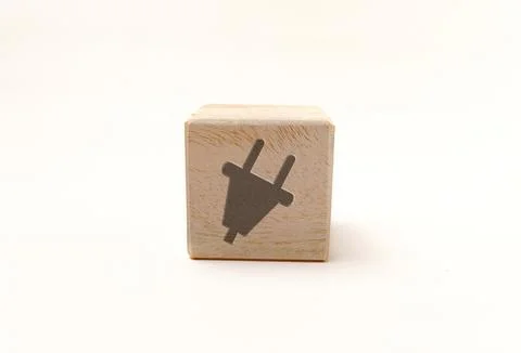 Single wooden block cube featuring a gray electrical plug power icon on nat.. Stock Photos